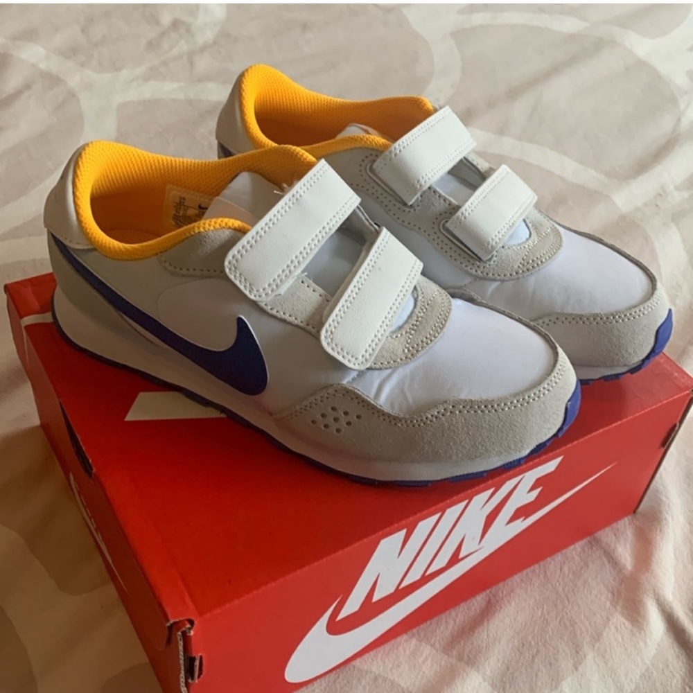 Nike Kids White Sneakers with Yellow Lining and Blue Swoosh